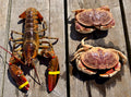 Lobster and crabs on a wooden surface